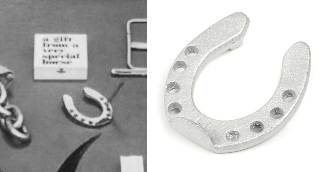 Black and white historical catalog photo from Carl Auböck showing a horseshoe shaped pencil holder with its box reading "a gift from a very special horse" next to a modern version of the same nickel plated horseshoe. 