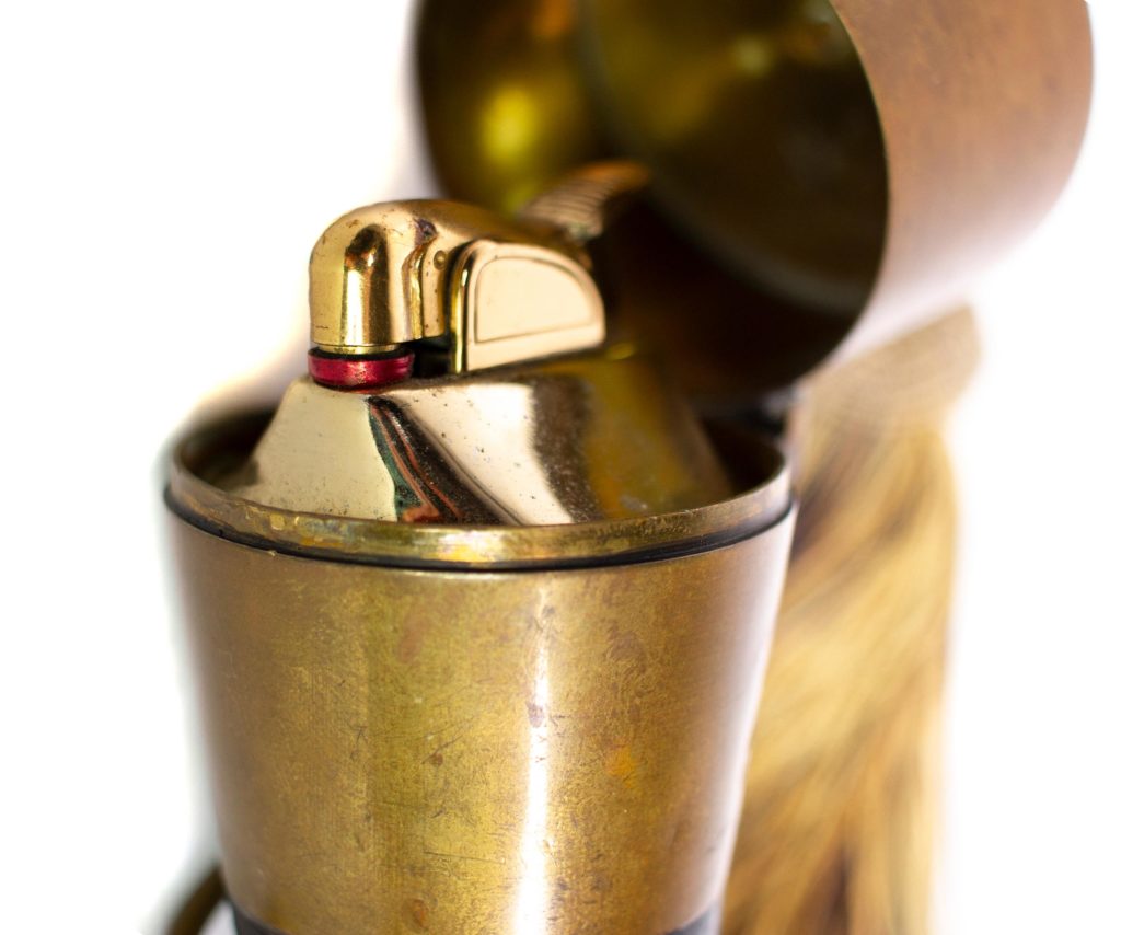 Closeup image of the brass figa lighter insert inside the case.