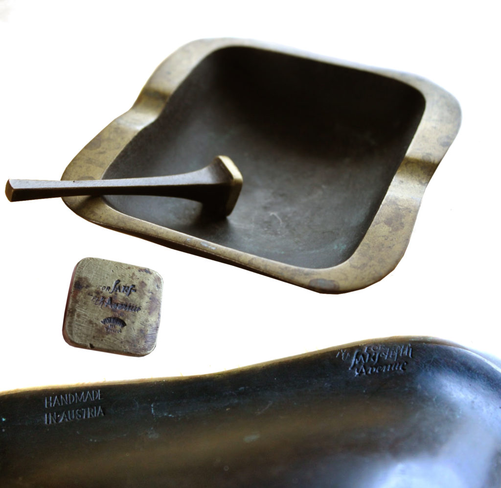 Richard Rohac designed brass ashtray and pipe tamper with applied black patina and polished highlights marked with "Handmade in Austria," "Made in Austria," and "For Saks Fifth Avenue".